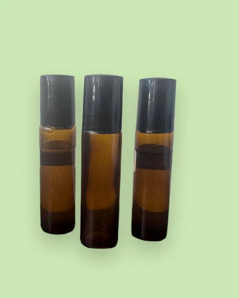 Three amber roller perfume bottles