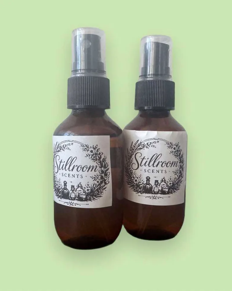 Two Stillroom Scents spray perfume bottles in amber glass